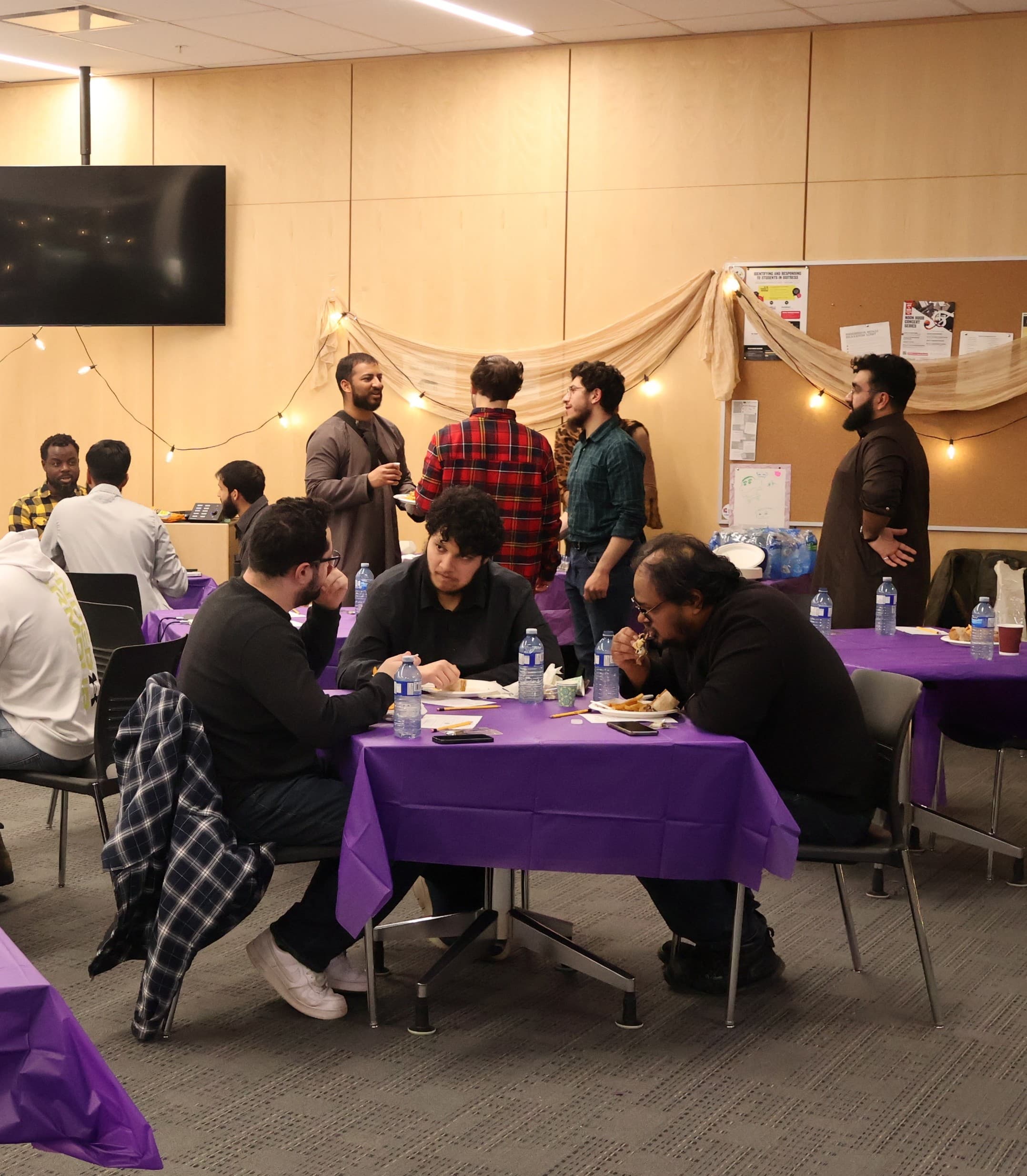 Several individuals gathered around tables, sharing food and conversation.